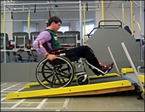 A photograph showing a manual wheelchair user on a ramp.