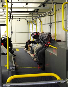 photo of a participant, who uses a walking aid, rising up from longitudinal seating in the bus simulator
