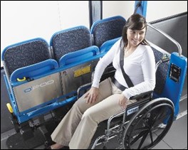 Photo of woman using the 3-point tie-down systems on an actual fixed-route bus.