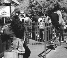 photo of sign with access symbol at entrance to waiting line
area