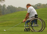 photo of man using wheelchair on golf
course