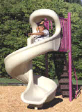 photo of a boy on spiral slide