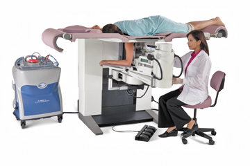Photograph of patient on a prone breast biopsy table while physician works underneath the table.