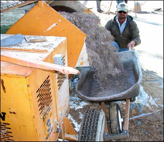 Figure 3---Loading of binder--EWF mixture from mortar mixer into wheelbarrow. 