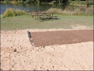 Figure 5---Termination of Soil-Sement portion of beach path. Geotextile fabric visible under completed SEWF surface. 