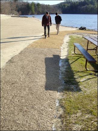 Figure 7---Beach path after 2 months of weathering. Junction of Soil-Sement and Vitri-Turf surfaces is just above the shadow cast by the picnic bench.