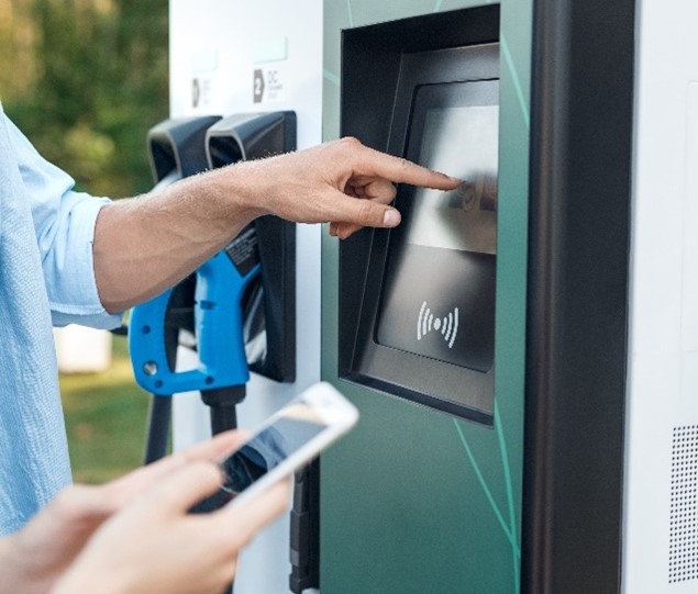 Person using a touchscreen on an EV charger