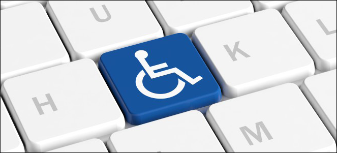 Close-up of a white computer keyboard with a focus on the H, J, and K keys. The J key is blue instead of white, and instead of the letter J, it has the international symbol of accessibility on it.