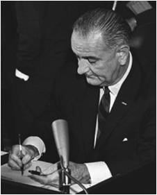 Lyndon B. Johnson signing legislation